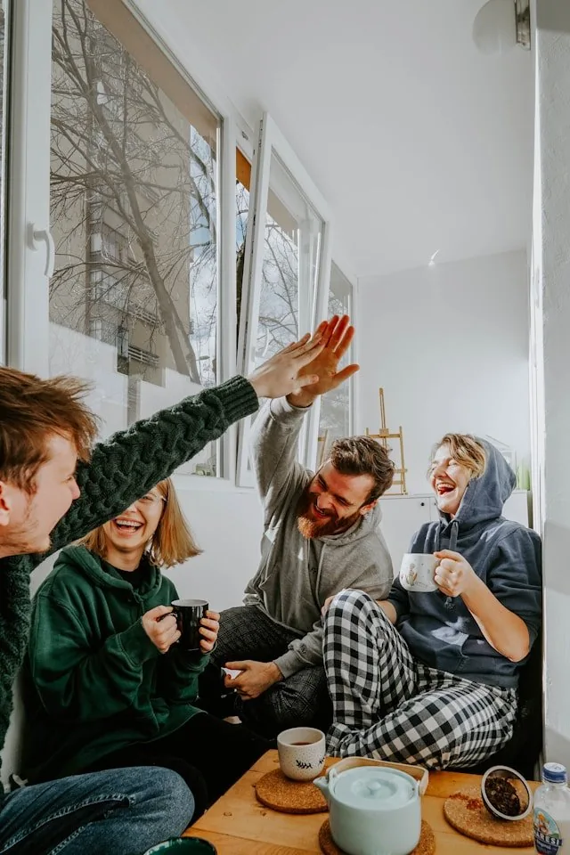 A family relaxing together at home with hot drinks